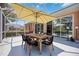 Covered lanai featuring a dining table set and view to interior and exterior at 5074 Flagstone Dr, Sarasota, FL 34238
