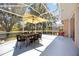 A screened lanai with a table, chairs, and a view of the water at 5074 Flagstone Dr, Sarasota, FL 34238