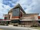 Modern library building with stone accents, large windows, and an American flag at 5074 Flagstone Dr, Sarasota, FL 34238