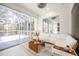 Bright living room with white sectional couch and seamless access to the screened in patio at 5074 Flagstone Dr, Sarasota, FL 34238