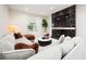 Cozy living room featuring a comfortable sectional, a sleek fireplace, and a large window letting in natural light at 5074 Flagstone Dr, Sarasota, FL 34238