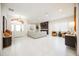 Spacious living room with bright white tile flooring, high ceilings, modern lighting, and decorative fireplace at 5074 Flagstone Dr, Sarasota, FL 34238