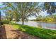 A tranquil pond view from the grassy shoreline at 5074 Flagstone Dr, Sarasota, FL 34238