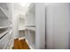 Spacious walk-in closet with custom shelving and hardwood floors at 5074 Flagstone Dr, Sarasota, FL 34238