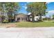 Spacious backyard with a screened-in lanai and lush landscaping, creating a serene outdoor space at 5240 Silver Charm Ter, Wesley Chapel, FL 33544