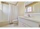 Traditional bathroom with a tub and shower combination and a white vanity and sink at 5240 Silver Charm Ter, Wesley Chapel, FL 33544