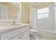 Bright bathroom featuring a shower-tub combination and a white vanity with cabinet storage at 5240 Silver Charm Ter, Wesley Chapel, FL 33544
