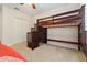 This bedroom features a bunk bed with stairs and built-in storage, plus a closet for convenience at 5240 Silver Charm Ter, Wesley Chapel, FL 33544