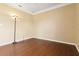 Bedroom showing neutral walls and wood floors, with an electric light fixture at 5240 Silver Charm Ter, Wesley Chapel, FL 33544