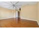 Bedroom featuring hardwood floors, yellow walls, fan, and a doorway at 5240 Silver Charm Ter, Wesley Chapel, FL 33544