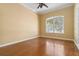 Bright and airy room with hardwood floors and a ceiling fan, providing a comfortable and inviting space at 5240 Silver Charm Ter, Wesley Chapel, FL 33544