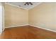 Spacious bedroom featuring hardwood floors, a ceiling fan, and ample natural light, creating a comfortable retreat at 5240 Silver Charm Ter, Wesley Chapel, FL 33544