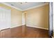 Bedroom featuring hardwood floors, double closets, and an open doorway with light yellow walls at 5240 Silver Charm Ter, Wesley Chapel, FL 33544