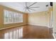 Bedroom featuring hardwood floors, yellow walls, and a window with shutter blinds at 5240 Silver Charm Ter, Wesley Chapel, FL 33544