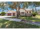 Attractive home featuring a three-car garage, stone accents, and lush landscaping, offering curb appeal and comfort at 5240 Silver Charm Ter, Wesley Chapel, FL 33544
