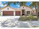 Charming single-story home with a well-manicured lawn and a three-car garage, set under a beautiful blue sky at 5240 Silver Charm Ter, Wesley Chapel, FL 33544