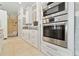 Close up on a kitchen with stainless steel appliances, and white cabinets with drawers at 5240 Silver Charm Ter, Wesley Chapel, FL 33544