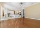 Open concept kitchen with white cabinets, island, hardwood floors, and modern appliances at 5240 Silver Charm Ter, Wesley Chapel, FL 33544