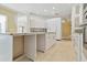Kitchen island with seating and sink, plus white cabinets with plenty of storage at 5240 Silver Charm Ter, Wesley Chapel, FL 33544