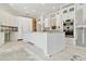 Modern kitchen with white cabinets, a large island, and new appliances at 5240 Silver Charm Ter, Wesley Chapel, FL 33544