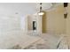 Open living area with neutral walls, a hanging light, and tile floors being installed at 5240 Silver Charm Ter, Wesley Chapel, FL 33544