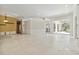 Spacious living room with tile flooring, sliding glass doors, and decorative molding at 5240 Silver Charm Ter, Wesley Chapel, FL 33544