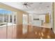 Open concept living space with access to the kitchen and views of the screened-in pool at 5240 Silver Charm Ter, Wesley Chapel, FL 33544