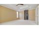 Primary bedroom showing neutral walls, tray ceiling, and a side window for lots of natural light at 5240 Silver Charm Ter, Wesley Chapel, FL 33544