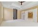 Large main bedroom with tray ceiling and dual closets allows passage to other parts of the house at 5240 Silver Charm Ter, Wesley Chapel, FL 33544