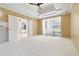 Spacious main bedroom boasts a tray ceiling and access to outdoor patio through sliding glass doors at 5240 Silver Charm Ter, Wesley Chapel, FL 33544