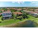 Aerial view showcasing the property with landscaped backyard, pond, and surrounding neighborhood at 5511 Foxfire Run, Lakewood Ranch, FL 34211