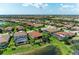 Overhead view of a neighborhood featuring ponds, swimming pools, and manicured lawns under a sunny sky at 5511 Foxfire Run, Lakewood Ranch, FL 34211