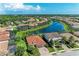 Beautiful aerial view of houses surrounding a long lake, and tropical landscaping in a wonderful neighborhood at 5511 Foxfire Run, Lakewood Ranch, FL 34211