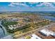 Expansive aerial view of a vibrant community featuring lakes, lush landscaping, and well-maintained homes under a sunny sky at 5511 Foxfire Run, Lakewood Ranch, FL 34211