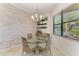 Cozy dining area featuring a glass table and natural light, perfect for enjoying meals at 5511 Foxfire Run, Lakewood Ranch, FL 34211
