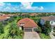 Beautiful exterior with a paver driveway, a two car garage, manicured landscaping and a red tiled roof at 5511 Foxfire Run, Lakewood Ranch, FL 34211