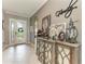 Inviting foyer with decorative console table, tiled flooring, and attractive front door at 5511 Foxfire Run, Lakewood Ranch, FL 34211