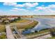 Picturesque lakeside view with lush green spaces, a walking path, and a charming bridge, perfect for serene strolls at 5511 Foxfire Run, Lakewood Ranch, FL 34211