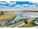 Scenic lake view from a community with manicured landscaping, and a walking path, offering serene outdoor recreation at 5511 Foxfire Run, Lakewood Ranch, FL 34211