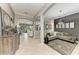 Open-concept living room showcasing gray color scheme, tile floors and elegant archways at 5511 Foxfire Run, Lakewood Ranch, FL 34211