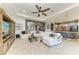 Open-concept living room leading into kitchen, featuring a large sofa and entertainment center at 5511 Foxfire Run, Lakewood Ranch, FL 34211
