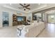 Spacious living area featuring a ceiling fan, large sofa, and open layout with tiled floors at 5511 Foxfire Run, Lakewood Ranch, FL 34211
