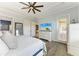 Comfortable main bedroom featuring wood floors, a tv, and a door to the outdoor living area at 5511 Foxfire Run, Lakewood Ranch, FL 34211