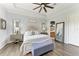 Cozy main bedroom with wood floors, a king bed, and soft, neutral tones at 5511 Foxfire Run, Lakewood Ranch, FL 34211