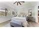 Serene main bedroom featuring a king bed, wood floors, and a bright window at 5511 Foxfire Run, Lakewood Ranch, FL 34211