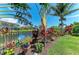 Scenic backyard view featuring a tranquil pond surrounded by lush landscaping at 5511 Foxfire Run, Lakewood Ranch, FL 34211