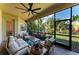 Inviting screened patio with seating, a ceiling fan, and scenic views of the lush backyard at 5511 Foxfire Run, Lakewood Ranch, FL 34211