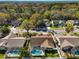 An aerial view shows several homes, one with a sparkling swimming pool and screened-in patio at 5565 Sweetwater Oak Dr, Sarasota, FL 34232