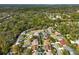 An aerial view features the neighborhood's well-maintained homes, mature trees, and green spaces at 5565 Sweetwater Oak Dr, Sarasota, FL 34232