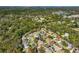 An aerial perspective shows the desirable community with beautiful homes, pools, and green surroundings at 5565 Sweetwater Oak Dr, Sarasota, FL 34232